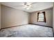 Spacious bedroom with ceiling fan and large window at 1061 Woodlake Ln, Tega Cay, SC 29708