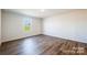 Simple bedroom with hardwood floors and a large window at 109 Tallulah Ct, Statesville, NC 28625