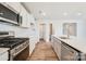 Modern kitchen with white cabinets, stainless steel appliances and an island at 109 Tallulah Ct, Statesville, NC 28625