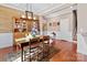 Dining room features wood floors, wood-paneled accent wall and chandelier at 112 Artisan Ct, Mooresville, NC 28117