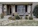 Inviting front porch with seating area, landscaping, and stone accents at 112 Artisan Ct, Mooresville, NC 28117