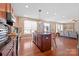 Open concept kitchen with island and views into the living room at 112 Artisan Ct, Mooresville, NC 28117