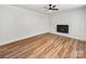 Spacious living area featuring a brick fireplace and vinyl plank flooring at 130 Oakhill St, Iron Station, NC 28080