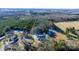 Aerial view of a house and surrounding property with trees and fields at 134 Gibbs Cir, Maiden, NC 28650