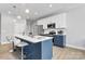 Open kitchen with white and blue cabinetry, an island, and stainless steel appliances at 134 Gibbs Cir, Maiden, NC 28650