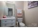 Powder room with sleek vanity, white fixtures, and neutral paint at 1370 Null Rd, Lincolnton, NC 28092