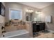 Luxurious bathroom with soaking tub, tiled backsplash, and vanity with dual sinks at 1370 Null Rd, Lincolnton, NC 28092