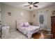 Charming bedroom with area rug, floral comforter, tufted headboard, and window with lots of light at 1370 Null Rd, Lincolnton, NC 28092
