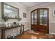 Elegant foyer with hardwood floors, decorative table, and striking double doors creating a warm welcome at 1370 Null Rd, Lincolnton, NC 28092