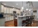 Gourmet kitchen with custom cabinetry, granite counters, stainless appliances, and eat-in bar area for casual dining at 1370 Null Rd, Lincolnton, NC 28092