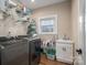 Well-organized laundry room with storage shelves, sink, and modern washer and dryer units at 1370 Null Rd, Lincolnton, NC 28092