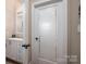 Laundry room door features an etched design, next to a half bath with decorative mirror at 1370 Null Rd, Lincolnton, NC 28092