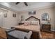 Primary bedroom features a large bed, sitting bench and tray ceiling at 1370 Null Rd, Lincolnton, NC 28092