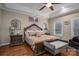 Primary bedroom features a large bed, sitting bench and tray ceiling at 1370 Null Rd, Lincolnton, NC 28092