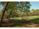 Picturesque property with a wooden fence, gate and expansive green field surrounded by trees at 1370 Null Rd, Lincolnton, NC 28092