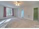 Bright bedroom featuring carpet, large window, and walk-in closet at 1385 The Xing, Rock Hill, SC 29732