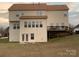 Two-story house back view, featuring a deck and walkout basement at 1916 Seefin Ct, Indian Trail, NC 28079