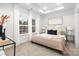 Spacious bedroom with plush bed and large windows at 5517 Skycrest Dr, Charlotte, NC 28269