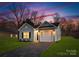 New construction home with gray siding, white garage door, and well-maintained lawn at 5517 Skycrest Dr, Charlotte, NC 28269