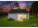 Gray house exterior with a small lawn at dusk at 5517 Skycrest Dr, Charlotte, NC 28269