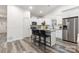 Modern kitchen with white cabinets, granite counters, and stainless steel appliances at 5517 Skycrest Dr, Charlotte, NC 28269