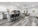 Open concept living room and kitchen with hardwood floors and neutral decor at 5517 Skycrest Dr, Charlotte, NC 28269
