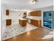 Kitchen with island, wood cabinets, marble-look tile, and hardwood floors at 801 Crestridge Rd, Statesville, NC 28677