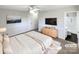 Virtually staged main bedroom with ensuite bathroom and large TV at 801 Crestridge Rd, Statesville, NC 28677