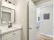 Modern bathroom with a quartz vanity top and black mirror at 8103 Cedar Glen Dr, Charlotte, NC 28212