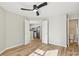 Bedroom with wood floors, ceiling fan and access to kitchen and bathroom at 8103 Cedar Glen Dr, Charlotte, NC 28212