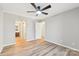 Bright bedroom with ceiling fan, wood-look floors, and access to a bathroom at 8103 Cedar Glen Dr, Charlotte, NC 28212