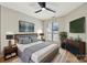 Spacious bedroom with large window, ceiling fan, and modern dresser at 8103 Cedar Glen Dr, Charlotte, NC 28212