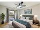 Comfortable bedroom with private balcony access and ceiling fan at 8103 Cedar Glen Dr, Charlotte, NC 28212