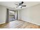 Bright bedroom with wood flooring, ceiling fan and sliding door to balcony at 8103 Cedar Glen Dr, Charlotte, NC 28212