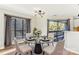 Elegant dining room with glass table, four chairs, and access to balcony at 8103 Cedar Glen Dr, Charlotte, NC 28212