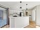 Updated kitchen with white cabinets, quartz countertops, and breakfast bar at 8103 Cedar Glen Dr, Charlotte, NC 28212