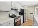 Modern kitchen with stainless steel appliances and marble backsplash at 8103 Cedar Glen Dr, Charlotte, NC 28212