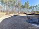 Private backyard with patio and view of wooded area at 8825 Chapel Grove Crossing Dr, Huntersville, NC 28078