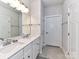 Clean bathroom with double vanity and modern fixtures at 8825 Chapel Grove Crossing Dr, Huntersville, NC 28078