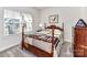 Charming bedroom with wood bed frame and window at 8825 Chapel Grove Crossing Dr, Huntersville, NC 28078