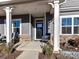 Inviting front porch with rocking chairs and white columns at 8825 Chapel Grove Crossing Dr, Huntersville, NC 28078