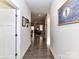 Bright hallway with hardwood floors, leading to living areas at 8825 Chapel Grove Crossing Dr, Huntersville, NC 28078