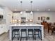 Modern kitchen with white cabinets, large island, and stainless steel appliances at 8825 Chapel Grove Crossing Dr, Huntersville, NC 28078