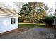 Landscaped backyard with a spacious patio and detached garage at 9501 Whitethorn Dr, Charlotte, NC 28277