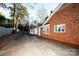 Red brick garage with white door and windows at 9501 Whitethorn Dr, Charlotte, NC 28277