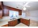 Classic kitchen features wood cabinets, double sink, and built-in dishwasher at 9501 Whitethorn Dr, Charlotte, NC 28277