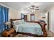 Spacious bedroom with a wooden sleigh bed, ceiling fan, and ample closet space at 980 Bear Poplar Rd, Cleveland, NC 27013