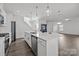 Modern kitchen with white cabinets, island, stainless steel appliances, and hardwood floors at 11058 Argosy Dr, Lancaster, SC 29720