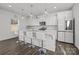 Modern kitchen with white cabinets, island with seating, and stainless steel appliances at 11058 Argosy Dr, Lancaster, SC 29720