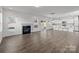 Spacious living room with hardwood floors, fireplace, and kitchen view at 11058 Argosy Dr, Lancaster, SC 29720
